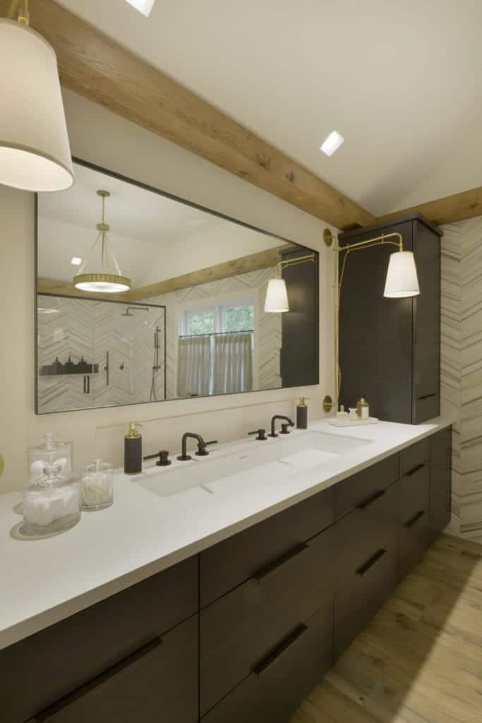 Classic bathroom features Chevron patterned walls and backsplash and Caesarstone-topped Smoky Oak Artcraft cabinetry.