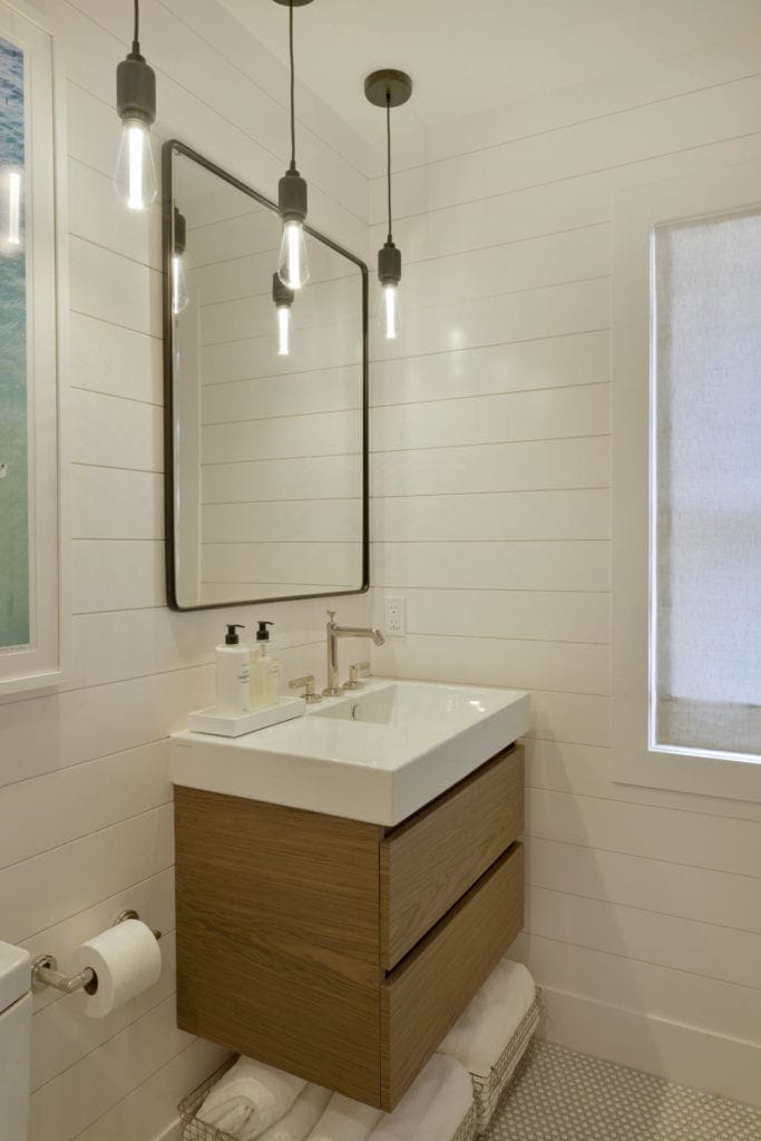 Contemporary bathroom with walnut floating vanity and ship lap walls.