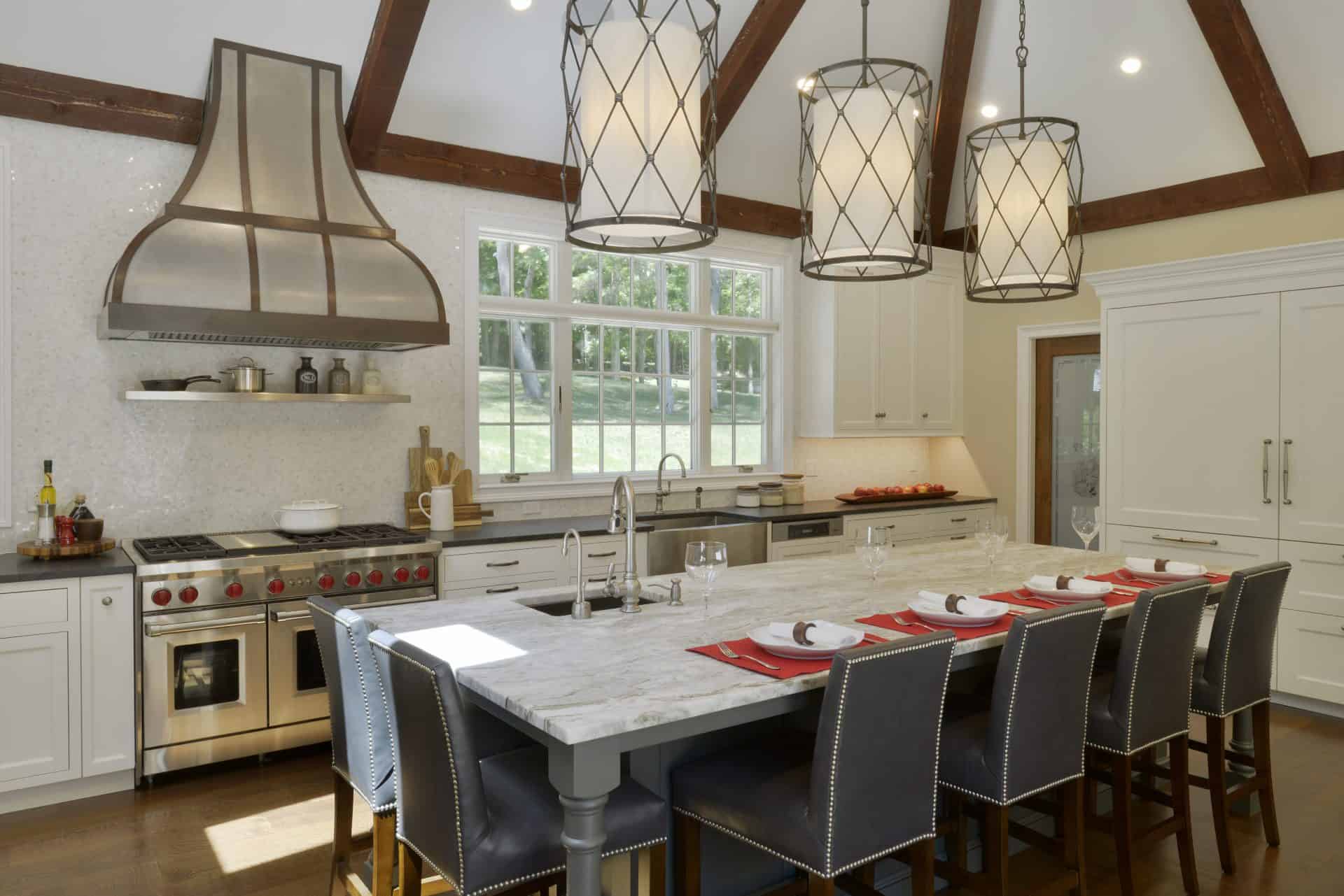 Somers NY kitchen features Wolf range with custom marble topped table