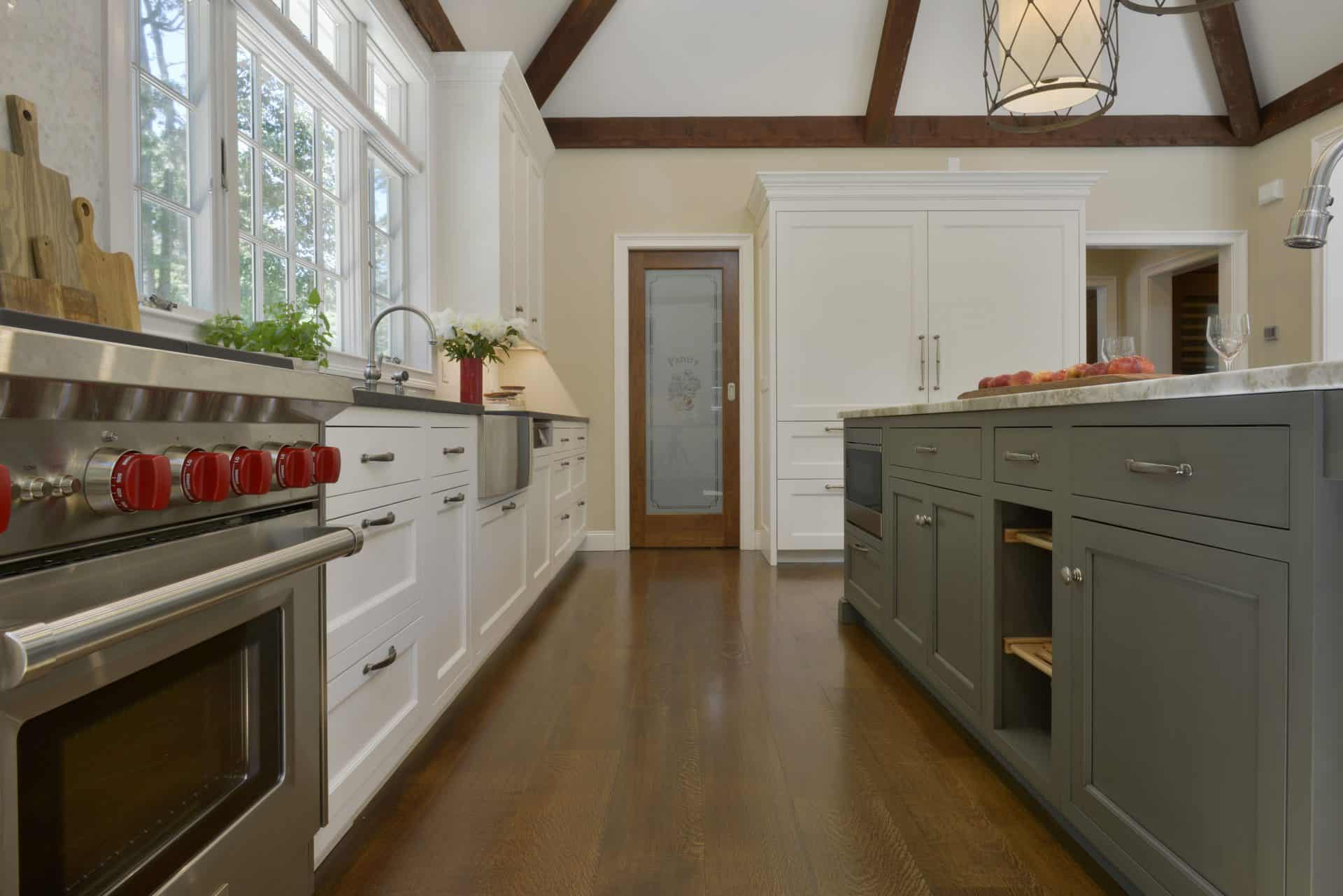 Classic Sommers NY kitchen features marble topped gray island with seating by Bilotta