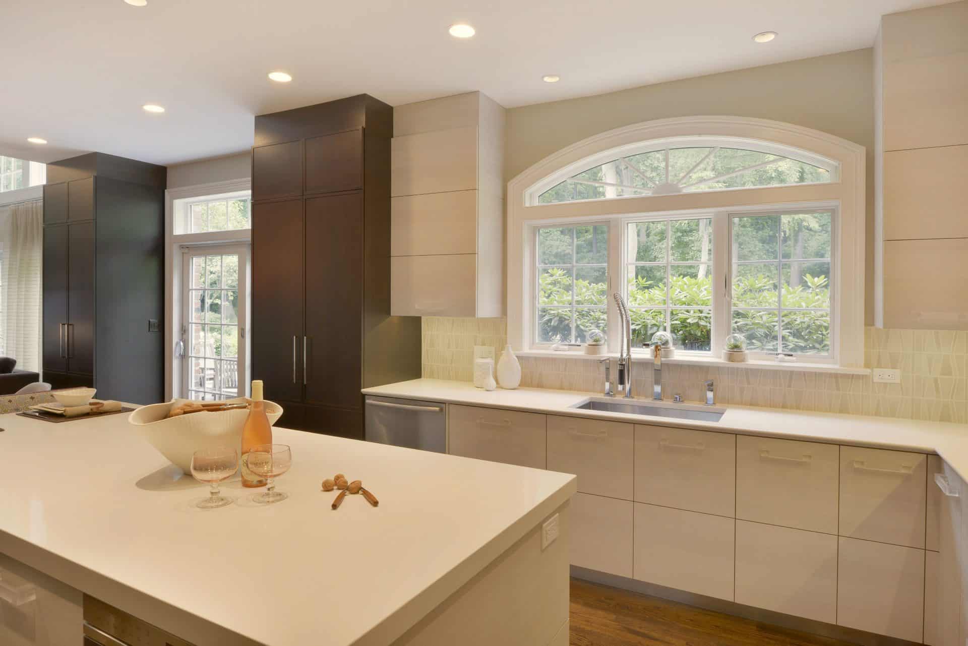 Custom Armonk, NY kitchen features custom, frameless Artcraft Cabinetry in a mix of walnut flat panel with white textured laminate.