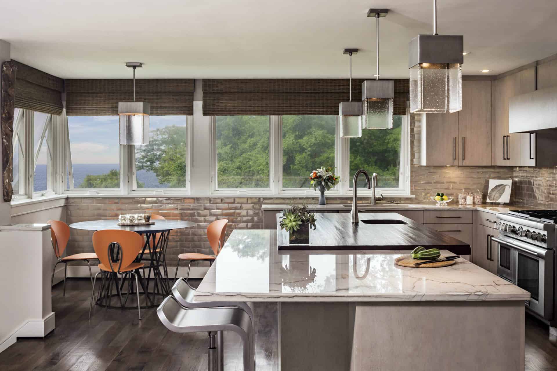 Stamford CT kitchen features  flat panel, frameless, fully custom mahogany cabinets by Bilotta, metallic, textured wallcovering and an island with seating.