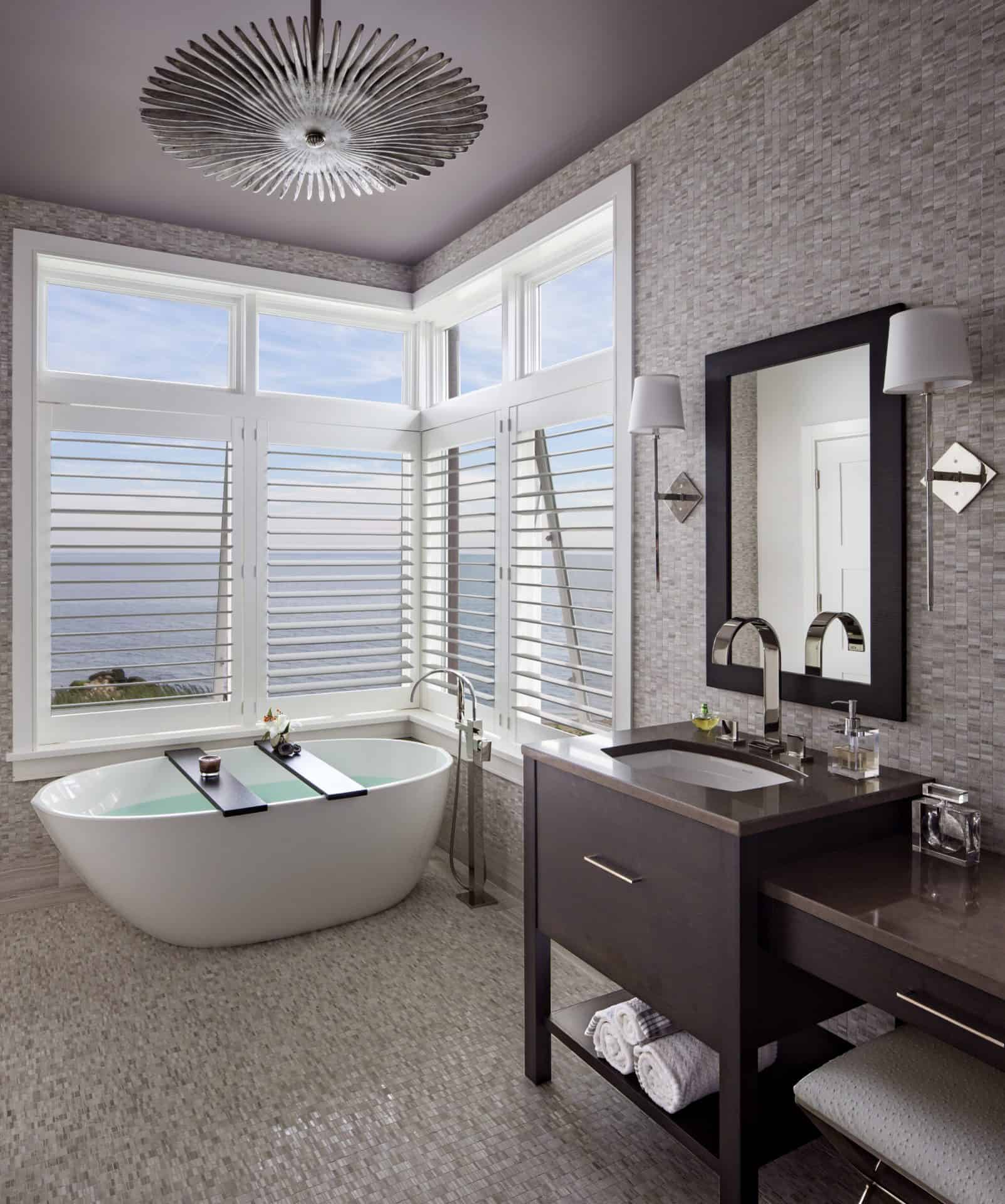 Elegant Stamford bathroom features bronze-tone Caesarstone topped Bilotta rift cut oak vanity with custom stain, Kallista sink and Graff faucet.