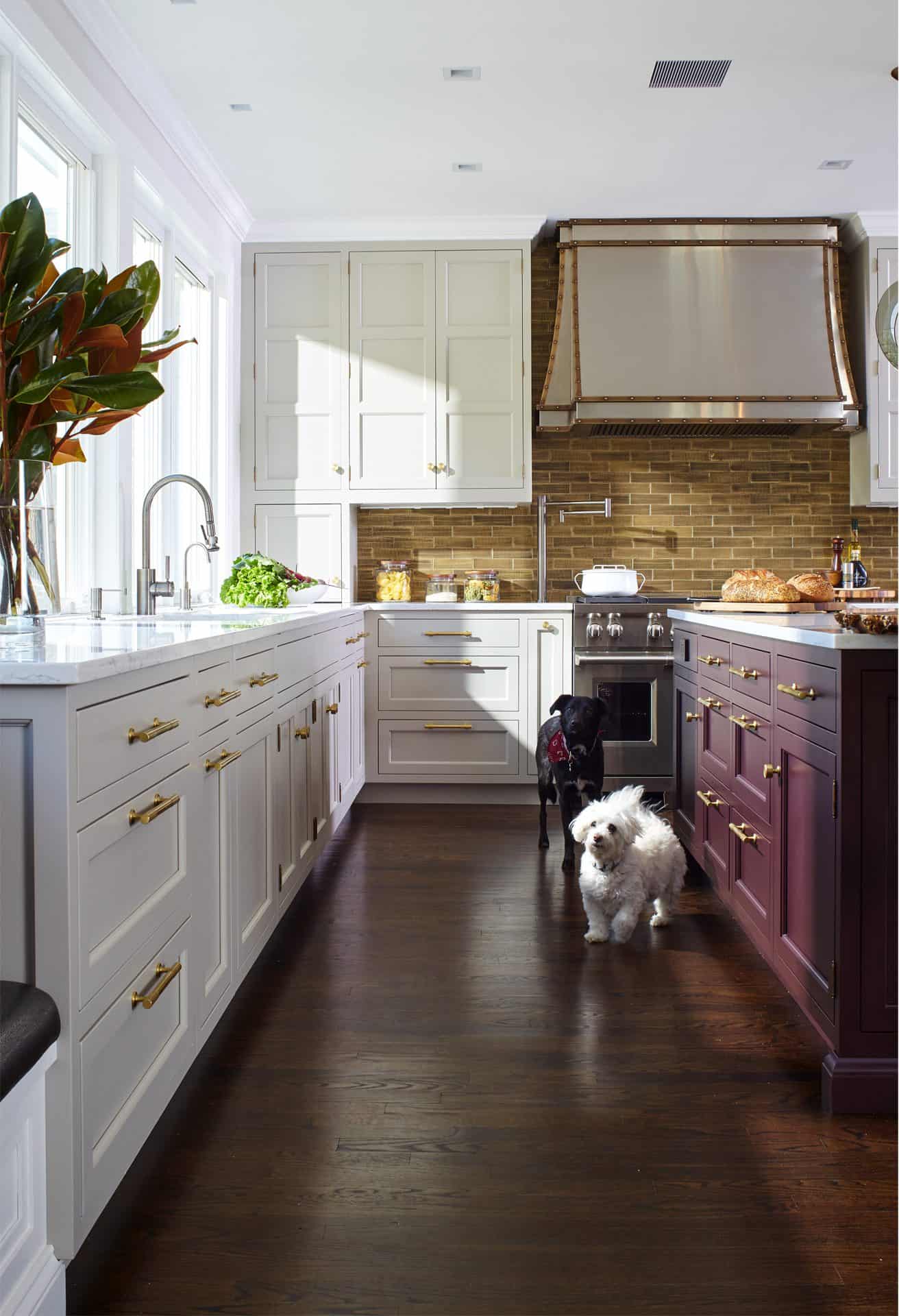 Shapely brass-trimmed stainless hood ties together the range, nickel faucets and brushed brass hardware.