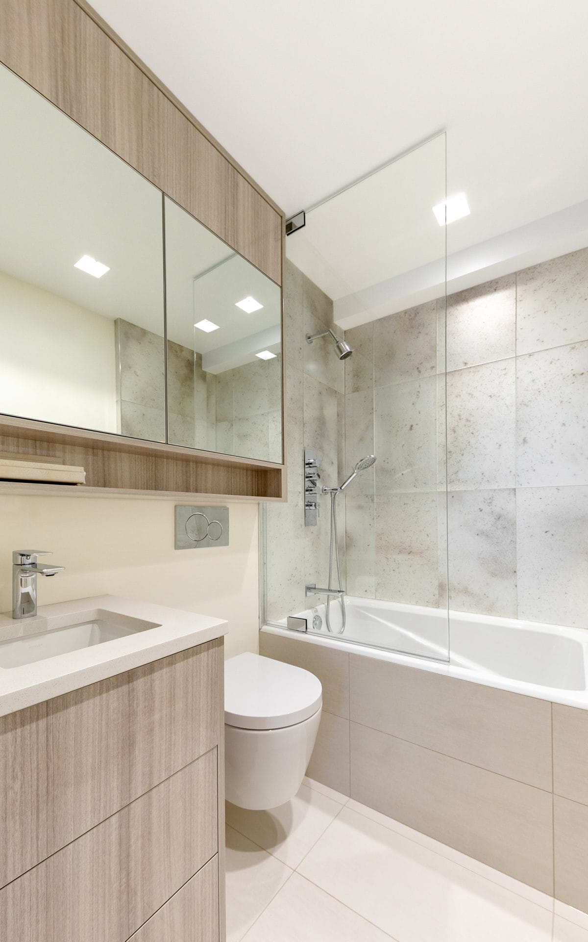 Custom bathroom features Bilotta horizontal-grained cabinetry and modern accessories and fixtures.
