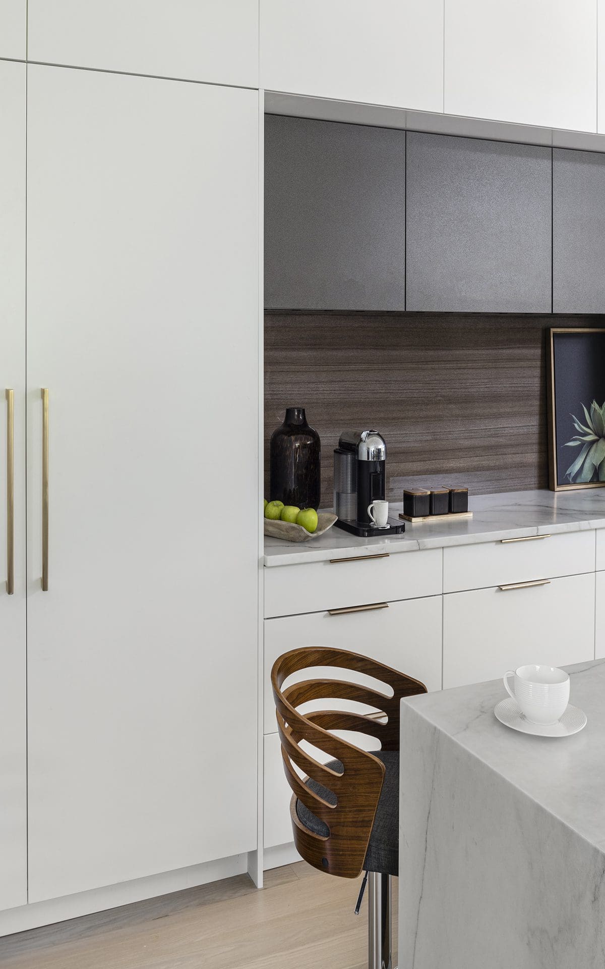 Custom kitchen features white Bilotta cabinetry and modern backsplash