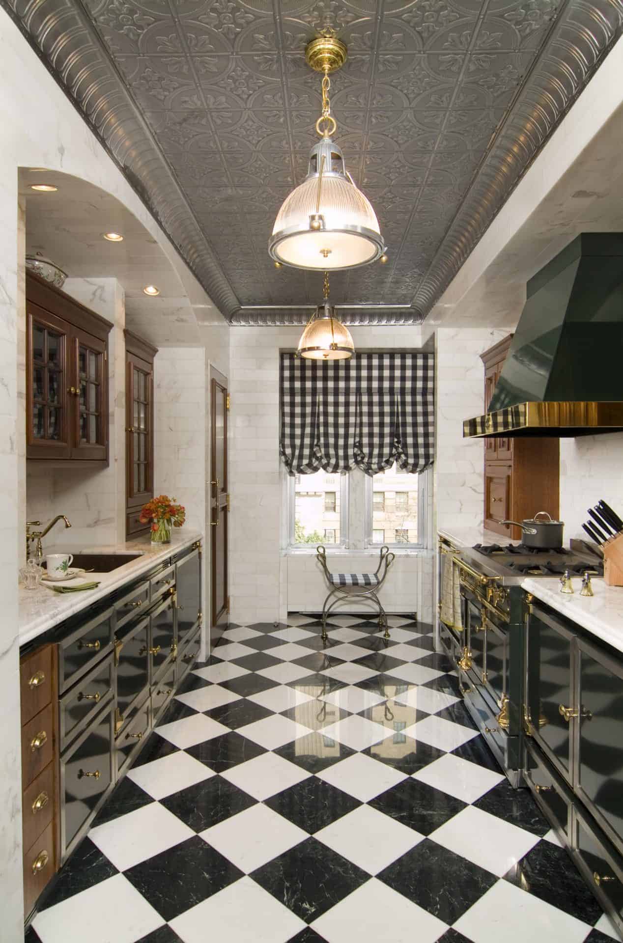 Galley kitchen features custom Bilotta cabinetry, checkerboard floor pattern and vintage pendant lights. 