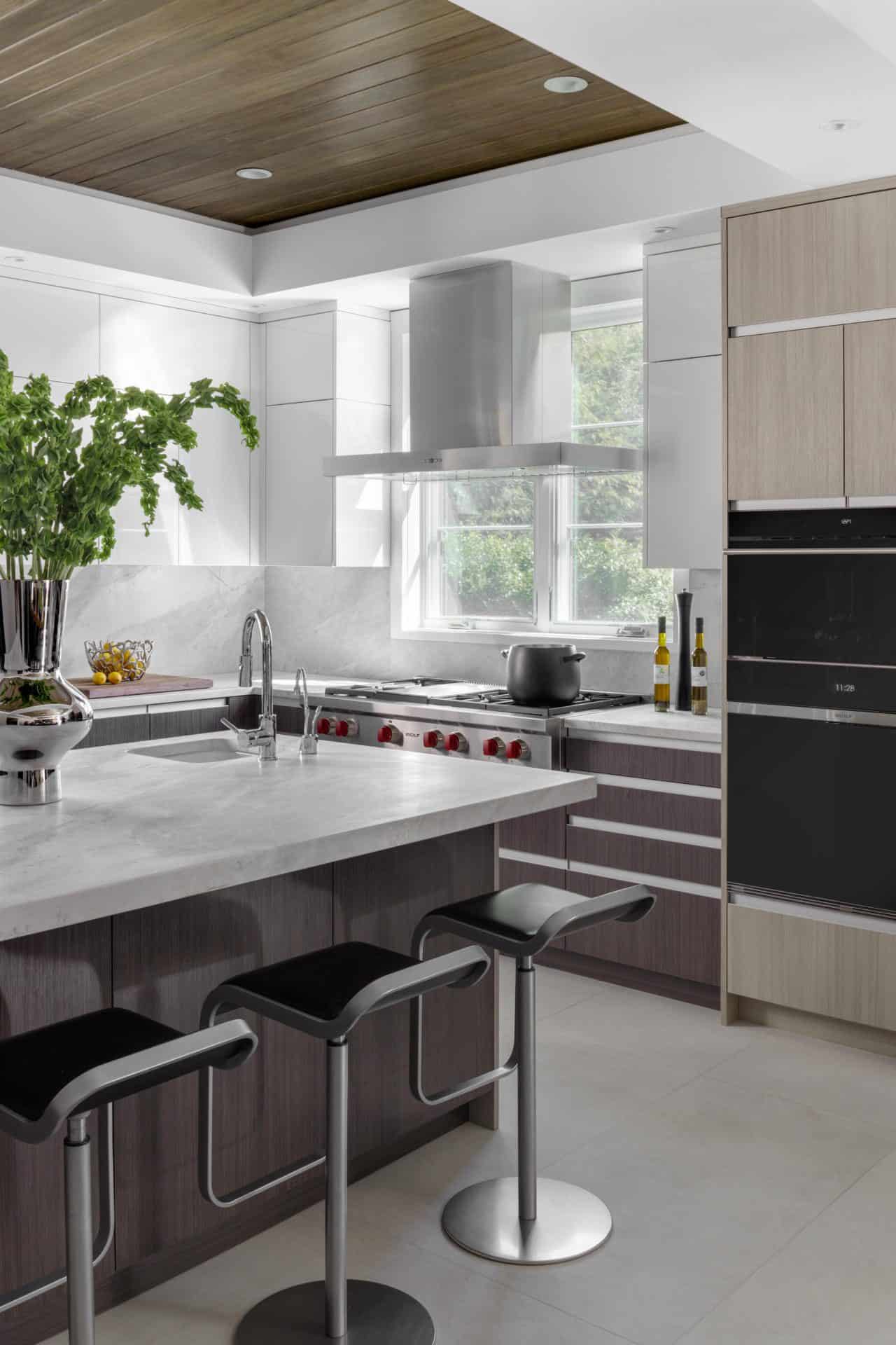 Contemporary kitchen features Bilotta cabinetry with ample custom island with seating. 