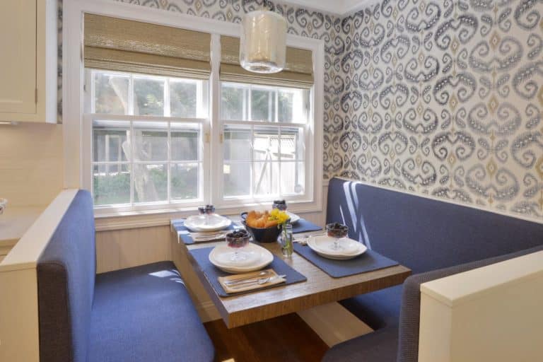 Image of a Bilotta Kitchen & Home custom kitchen with fabric on the walls over a custom banquette.
