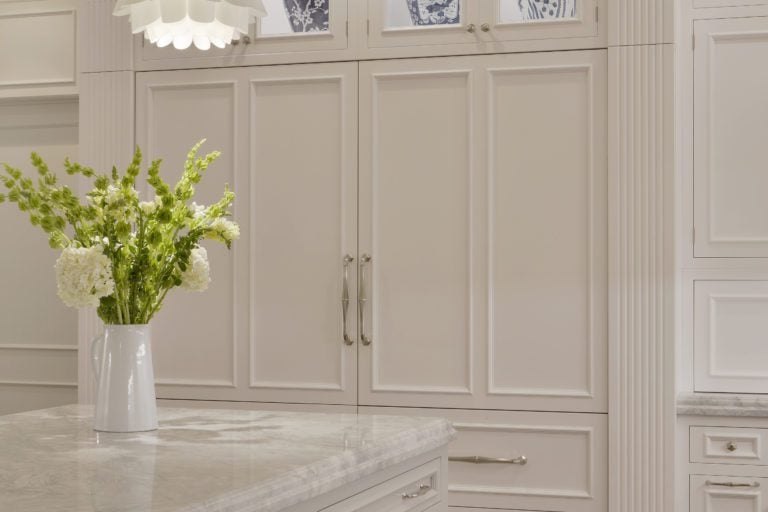 pilaster in a kitchen with white cabinets and wood flooring