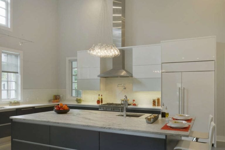 new york custom kitchen with dark cabinets, light countertops, and stainless steel toe kick