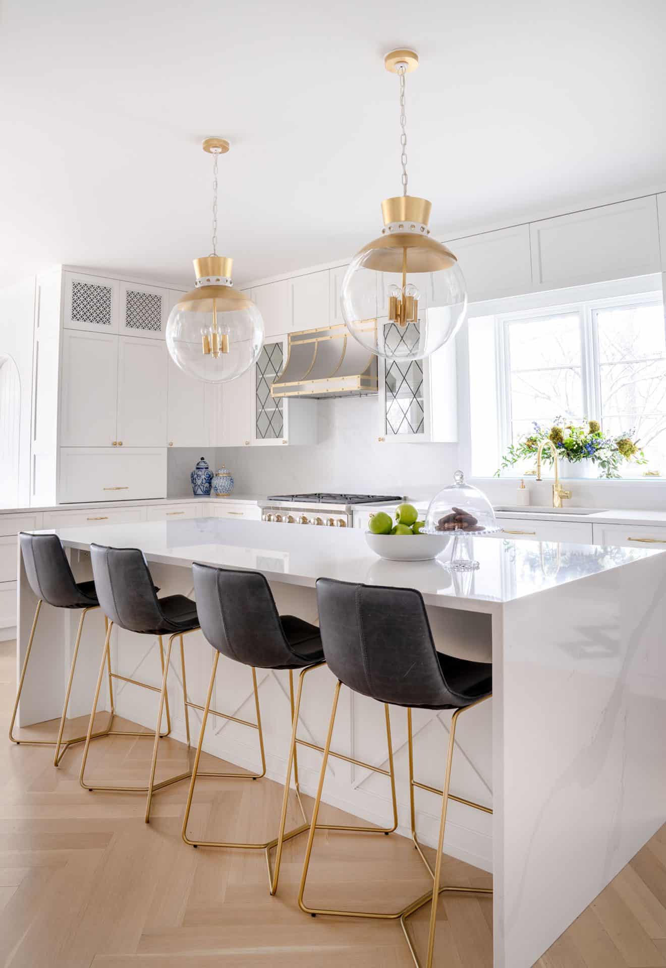Classic kitchen with white marble waterfall island, and gold accents