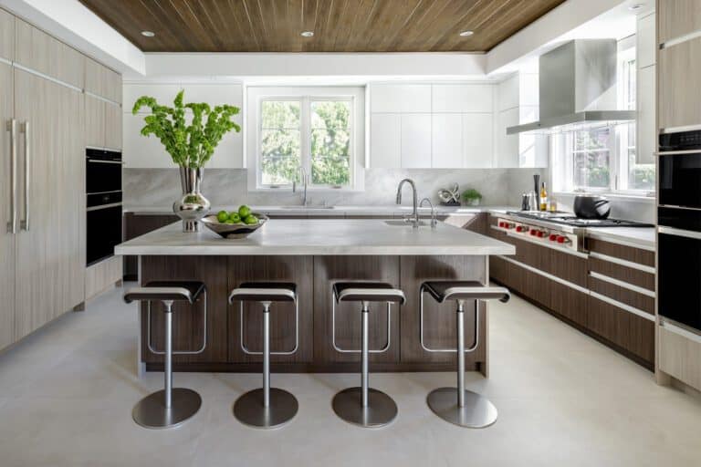 contemporary kitchen with sleek white upper cabinets and contrasting dark brown lower cabinets with integrated appliances and a large kitchen island