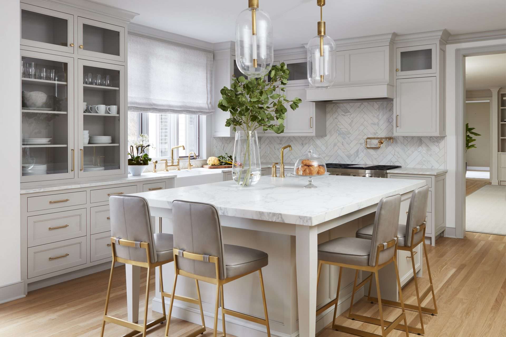 European kitchen features gray painted Bilotta custom cabinetry, black and gold La Cornue range and hood.
