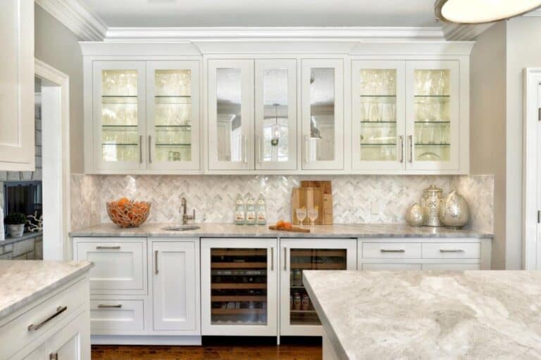 kitchen with different types of white cabinets, including glass front cabinets and antique mirror cabinets