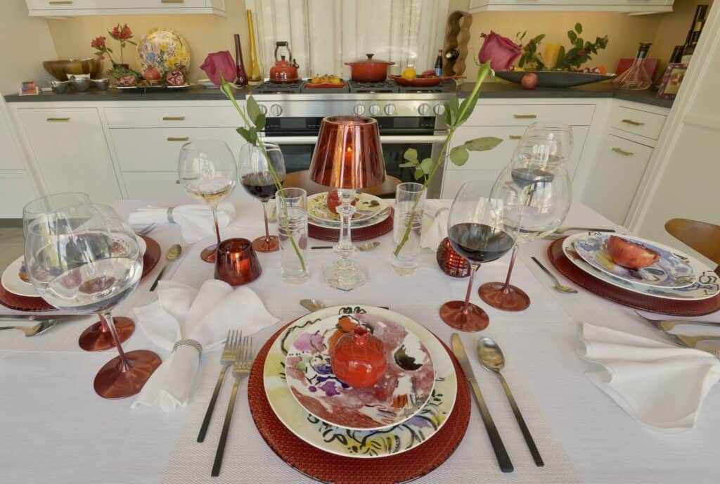 Tabletop design using red placements with yellow, purple and red floral accented plates. 